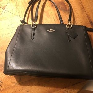 A classic coach bag. Never used, tags attached.
